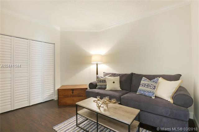 100 Uno Lago Drive, Unit 205 Juno Beach, FL 33408 - Photo 11 of 13 a living room with furniture and wooden floor