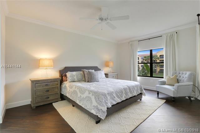 100 Uno Lago Drive, Unit 205 Juno Beach, FL 33408 - Photo 7 of 13 a bedroom with a bed and a couch