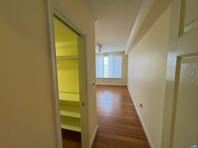 a view of a hallway with wooden floor