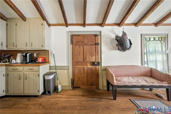 a view of a balcony with furniture and wooden floor