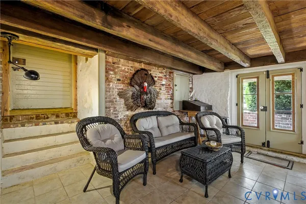 a spacious bedroom with furniture and a large window