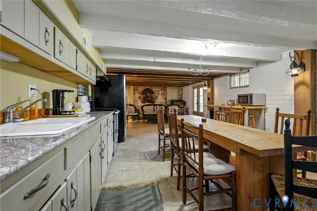 a kitchen with stainless steel appliances kitchen island granite countertop a sink cabinets and wooden floor