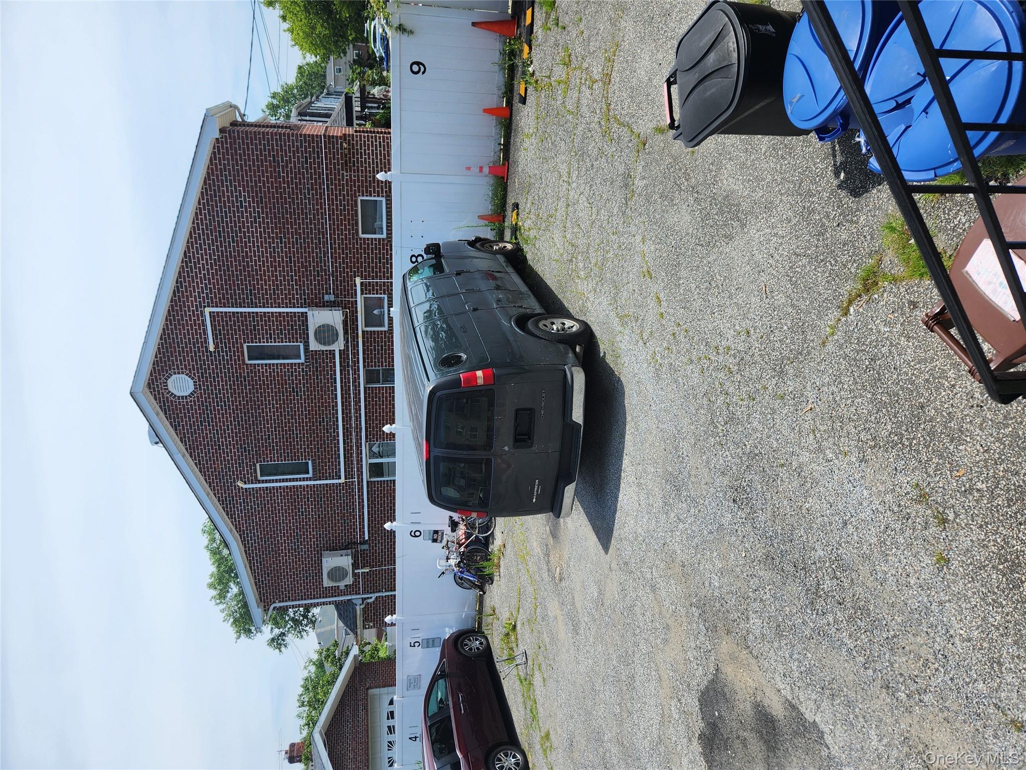 199-04 47th Avenue Queens, NY 11358 - Photo 4 of 5 a car parked in front of a house