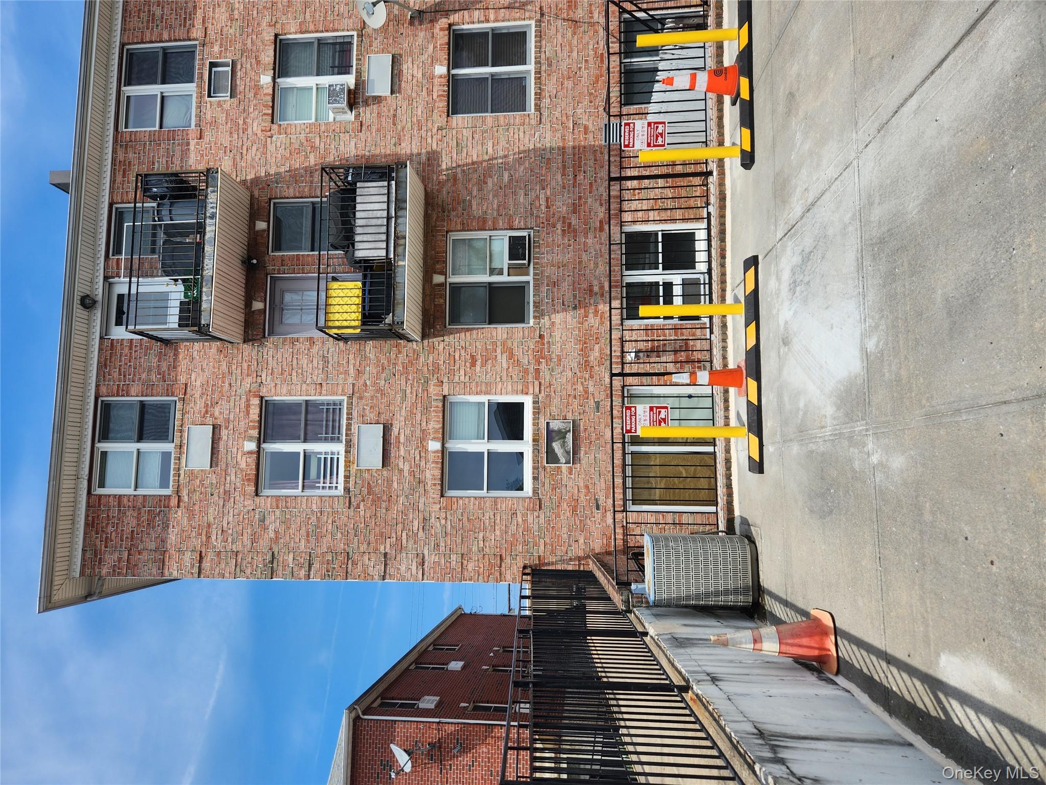 199-04 47th Avenue Queens, NY 11358 - Photo 5 of 5 a front view of building with large windows