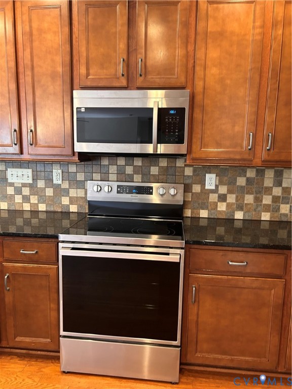 14537 Parracombe Lane Midlothian, VA 23112 - Photo 24 of 50 a kitchen with stainless steel appliances granite countertop a stove and a microwave