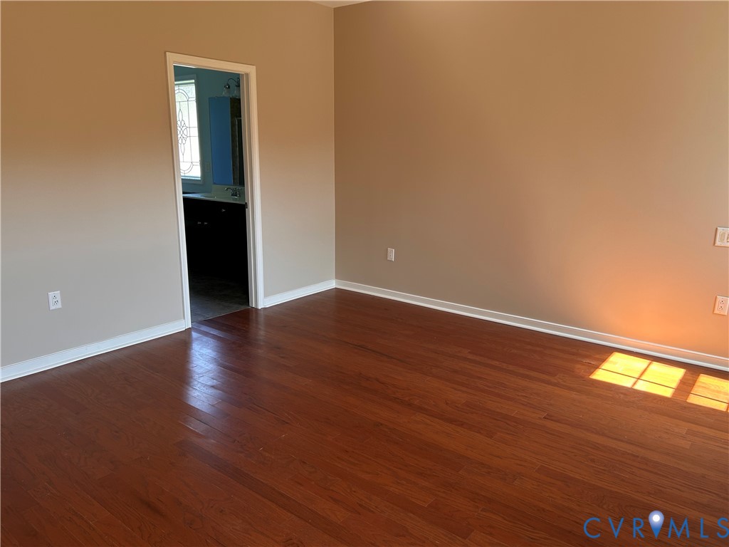 14537 Parracombe Lane Midlothian, VA 23112 - Photo 29 of 50 a view of an empty room with wooden floor and a window