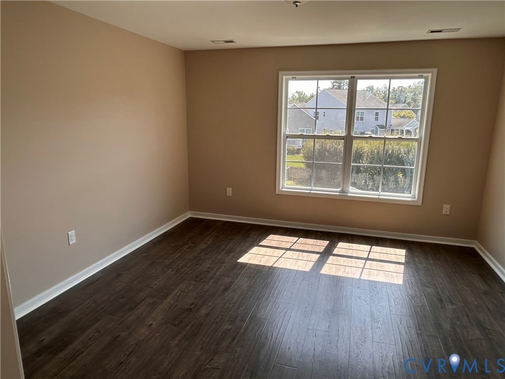 14537 Parracombe Lane Midlothian, VA 23112 - Photo 36 of 50 an empty room with wooden floor and windows