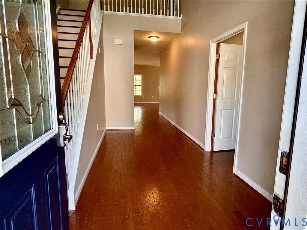 14537 Parracombe Lane Midlothian, VA 23112 - Photo 9 of 50 a view of a hallway with wooden floor and staircase