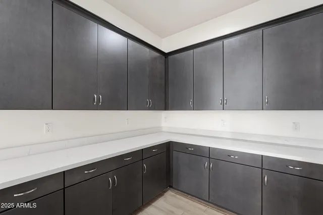 a large kitchen with stainless steel appliances kitchen island a large counter top and a wooden floors