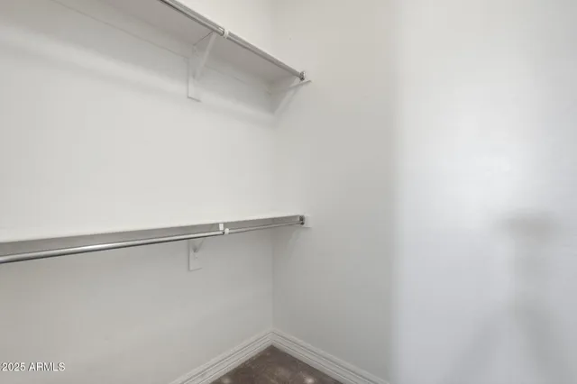 a view of a patio with a table and chairs under an umbrella with a large tree