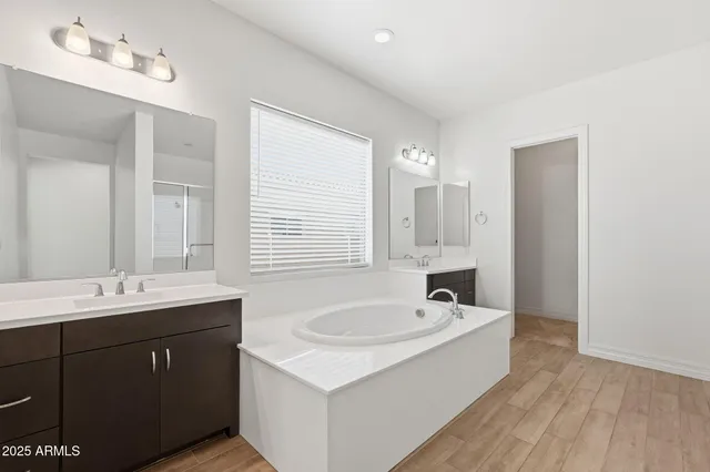 an aerial view of residential houses with outdoor space and trees