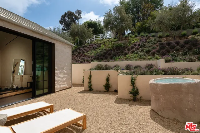 a view of backyard with outdoor seating and green space