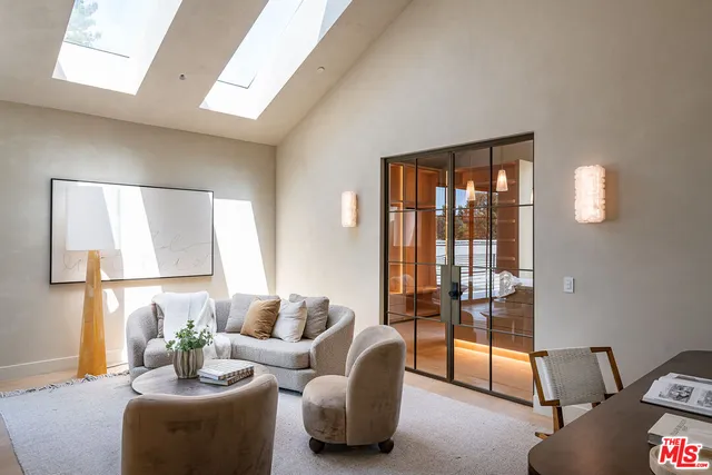 a living room with furniture and a floor to ceiling window
