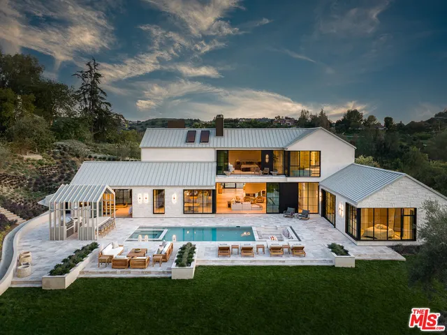 a front view of house with yard swimming pool and outdoor seating