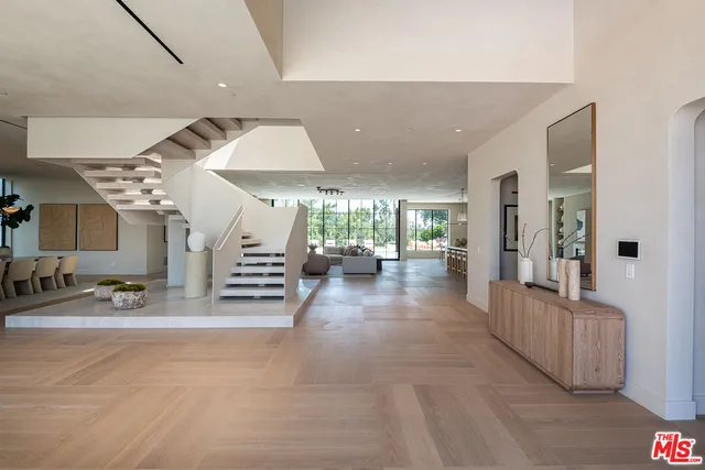 a view of a livingroom with furniture and an entryway
