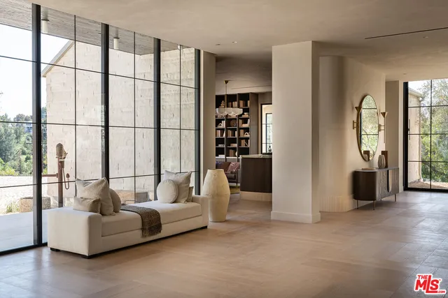 a living room with furniture and large windows