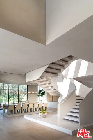 a living room with couches and chandelier