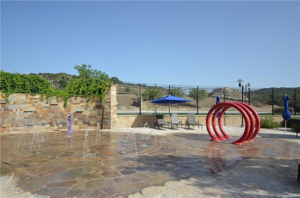 5629 Rio Chama Cove Austin, TX 78738 - Photo 28 of 34 Splash pad entertainment awaits, providing endless outdoor fun for residents of all ages.