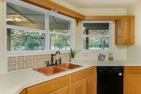 a kitchen with a sink and a window