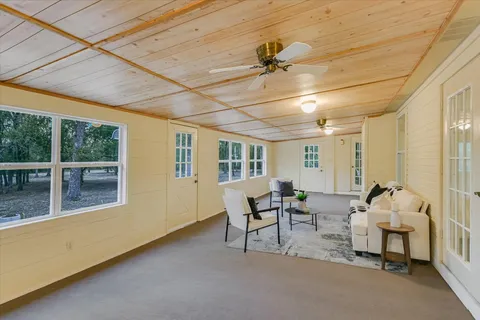 a view of a livingroom with furniture and a ceiling fan