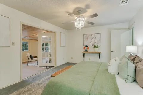 a bedroom with a bed and a chandelier