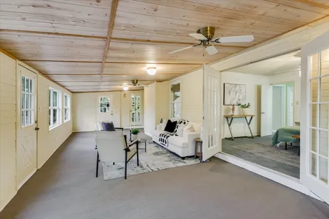 a living room with furniture and a chandelier