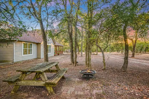 a view of a house with backyard and sitting area