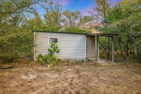 a backyard of a house with plants and outdoor seating