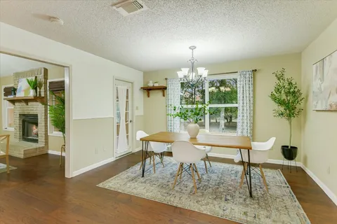 a view of a dining room with furniture window and wooden floor