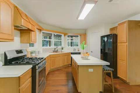 a kitchen that has a counter space and a stove
