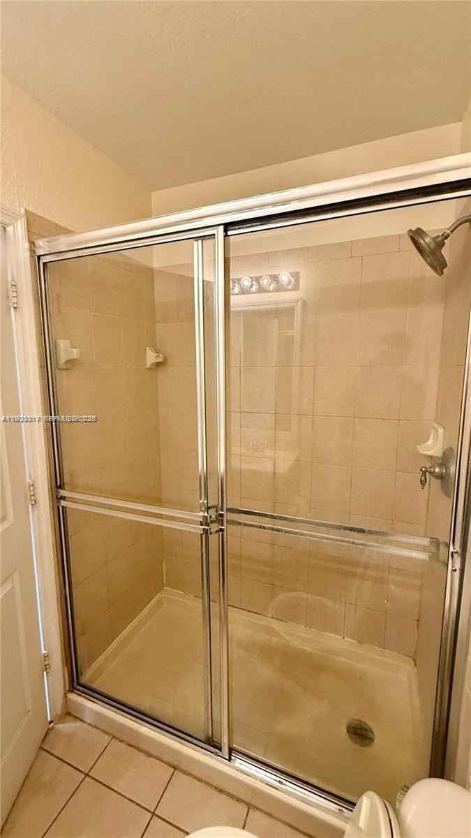 1918 Alamanda Way Riviera Beach, FL 33404 - Photo 14 of 23 a bathroom with a glass shower door