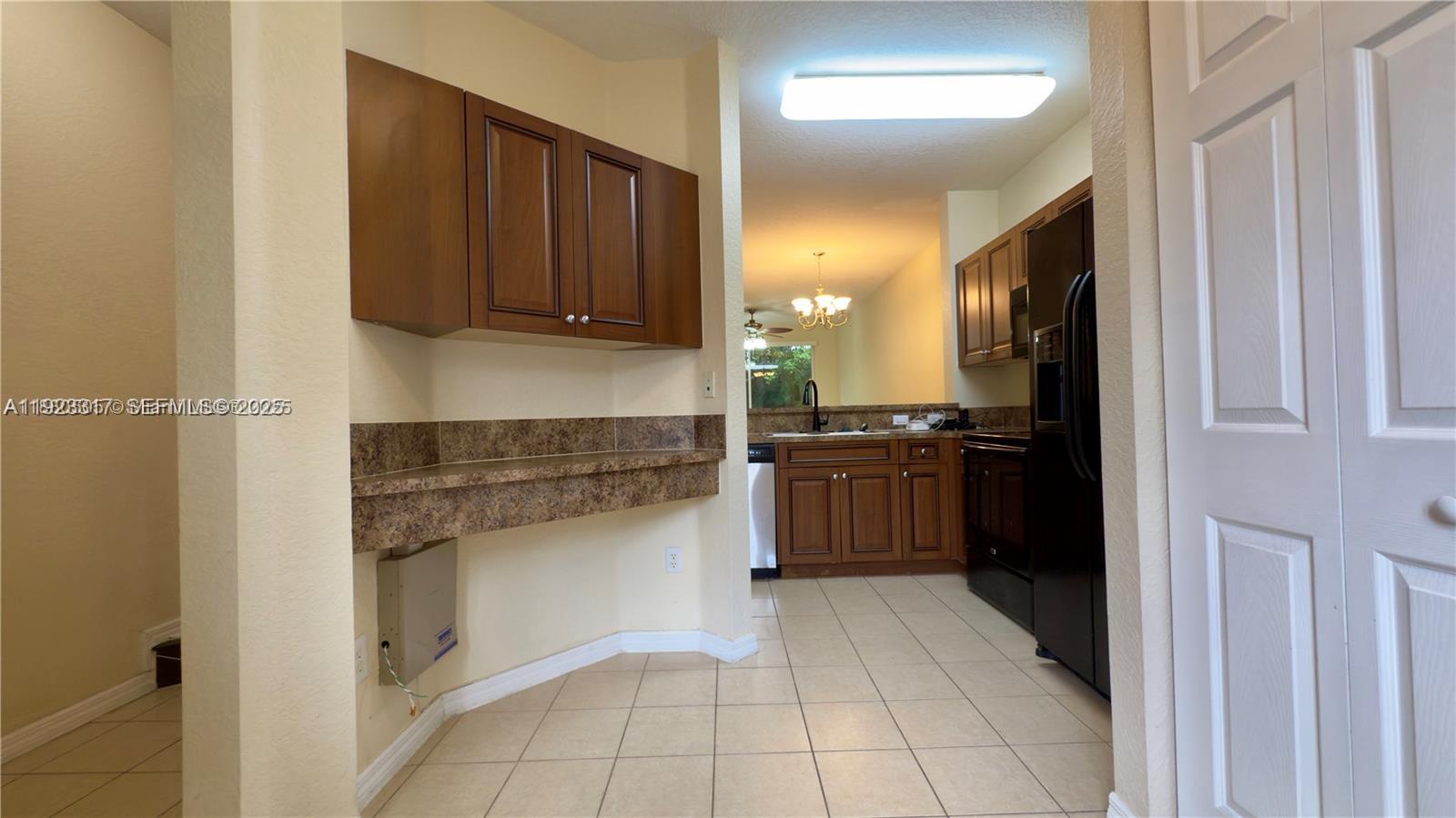 1918 Alamanda Way Riviera Beach, FL 33404 - Photo 2 of 23 a kitchen with a refrigerator and a sink