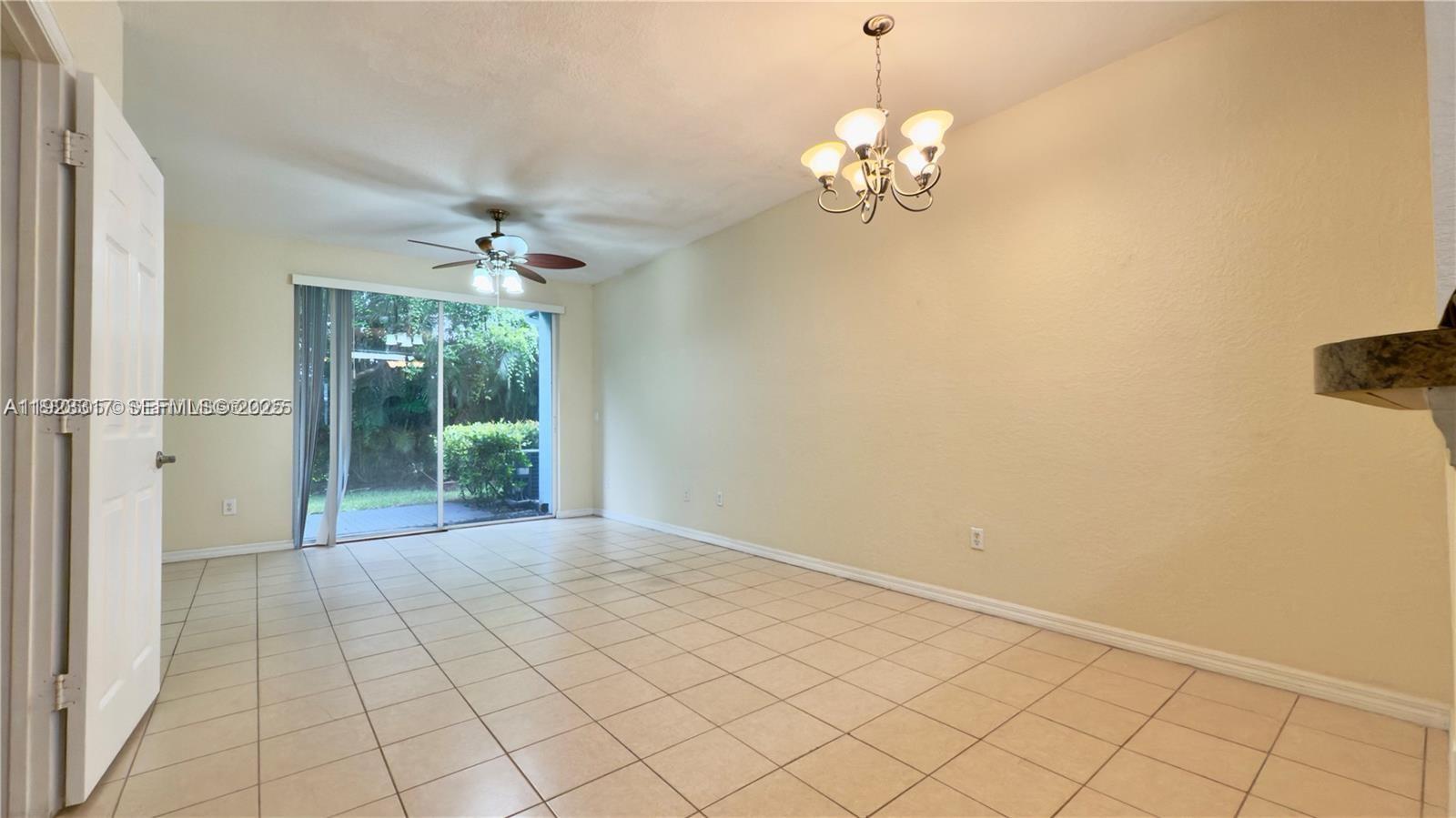 1918 Alamanda Way Riviera Beach, FL 33404 - Photo 5 of 23 a view of a chandelier in big room with wooden floor