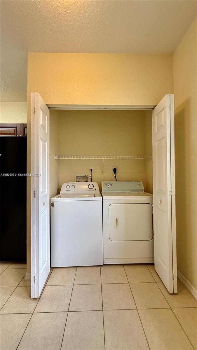 1918 Alamanda Way Riviera Beach, FL 33404 - Photo 8 of 23 a utility room with cabinets washer and dryer