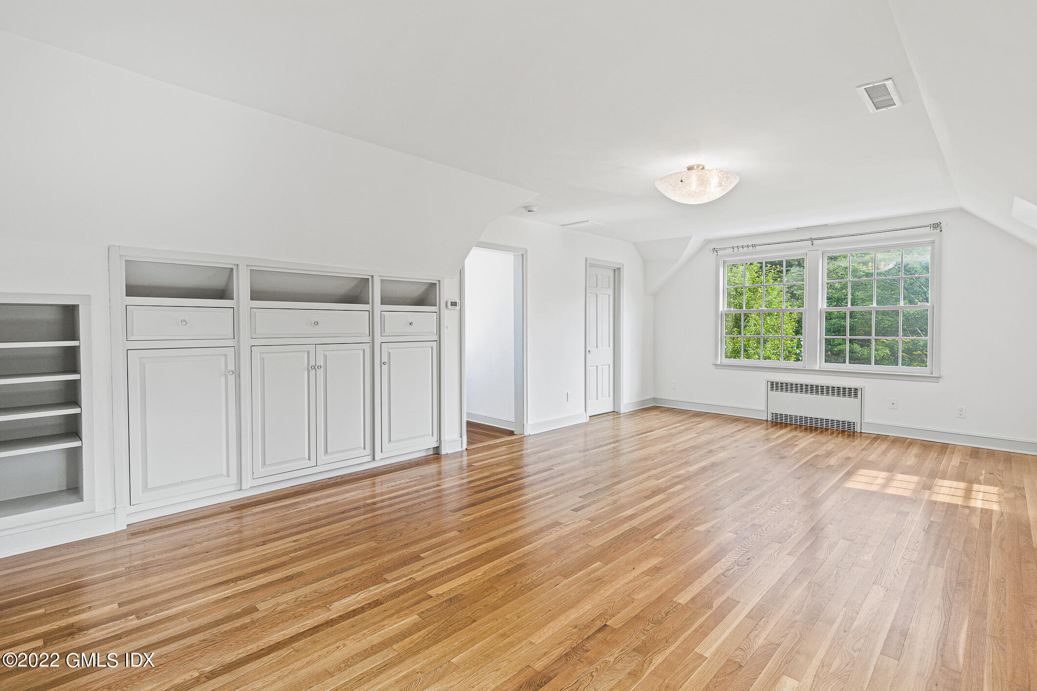 65 Doubling Road Greenwich, CT 06830 - Photo 11 of 18 an empty room with wooden floor cabinet and windows