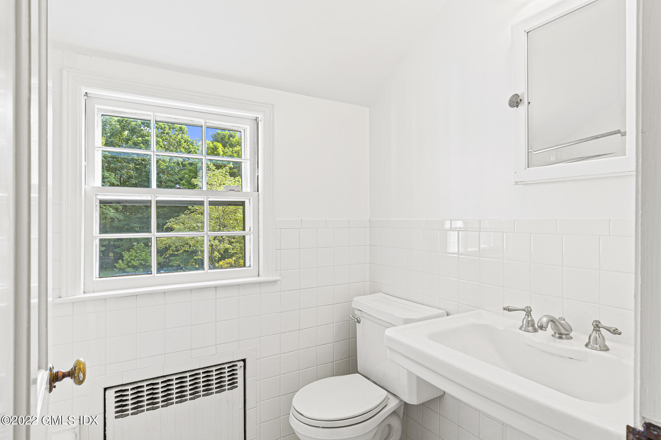65 Doubling Road Greenwich, CT 06830 - Photo 16 of 18 a bathroom with a sink toilet and window