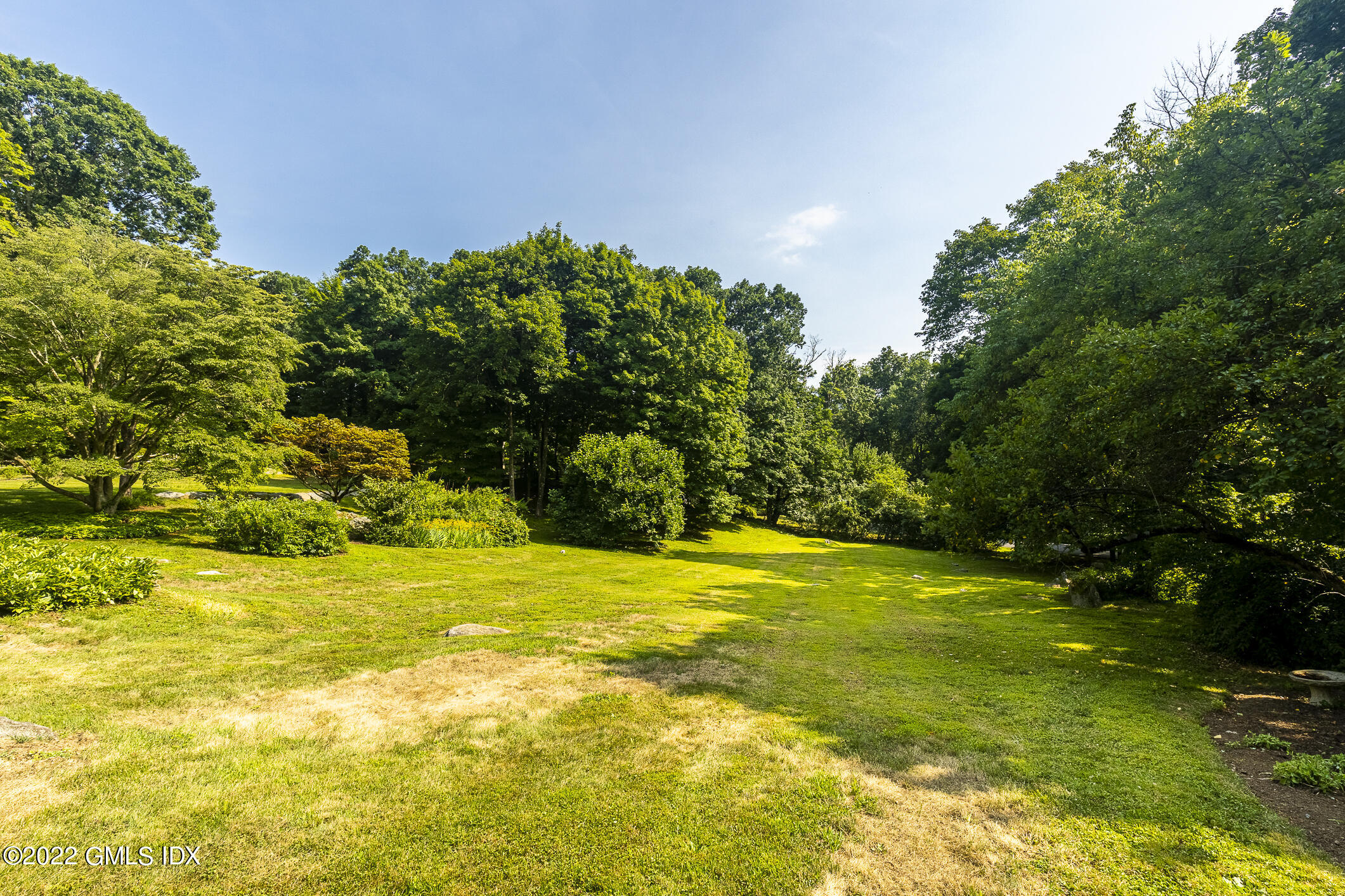 65 Doubling Road Greenwich, CT 06830 - Photo 18 of 18 a view of a big yard with plants and large trees