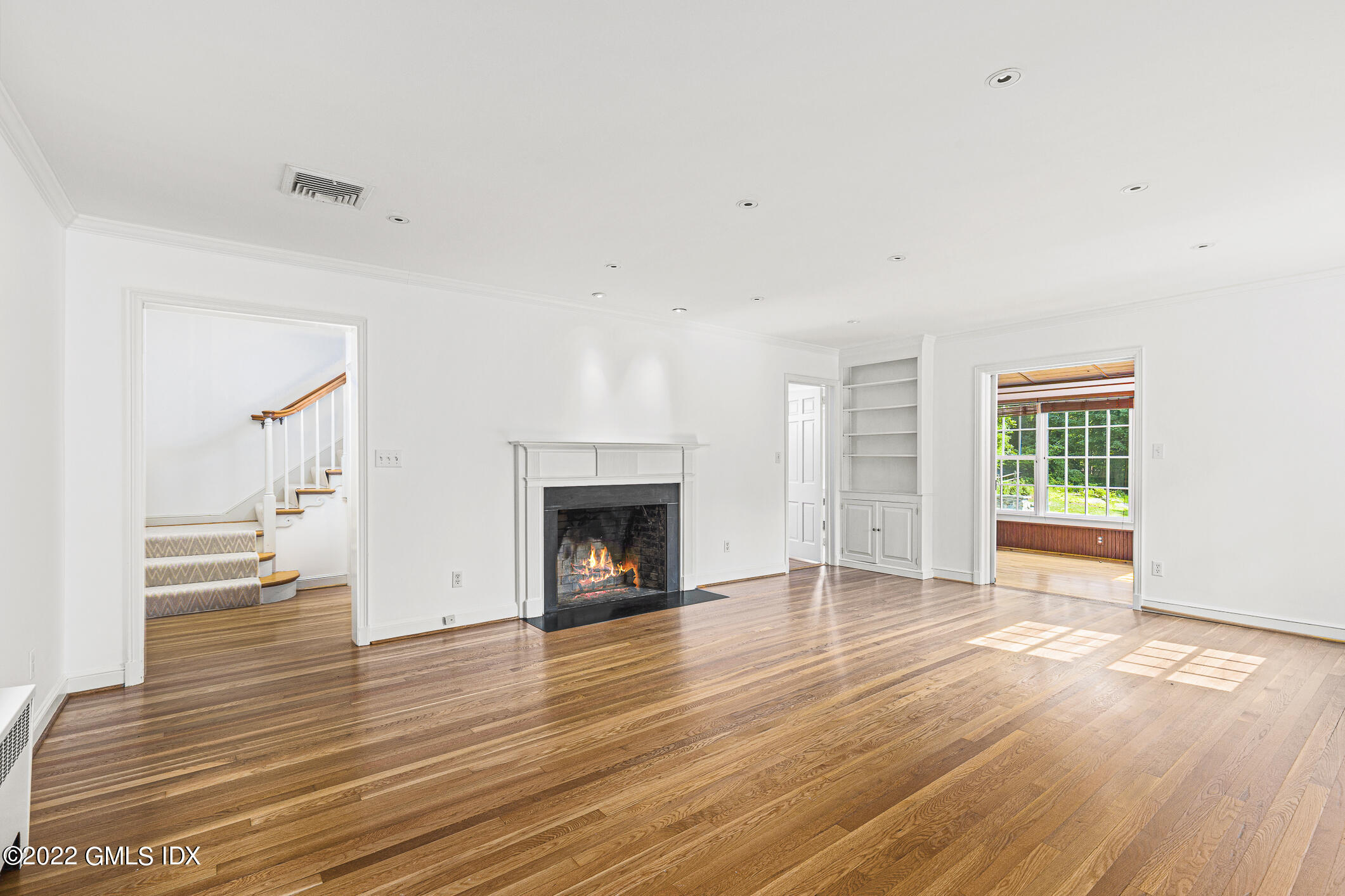 65 Doubling Road Greenwich, CT 06830 - Photo 5 of 18 a view of empty room with wooden floor and fireplace