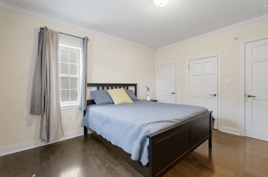 27 Commonwealth Avenue, Unit 1 Newton, MA 02467 - Photo 11 of 18 a bedroom with a bed and wooden floor