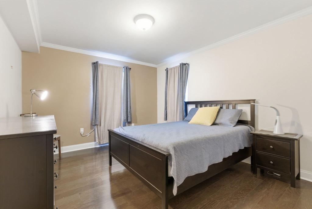 27 Commonwealth Avenue, Unit 1 Newton, MA 02467 - Photo 12 of 18 a bedroom with a bed and window