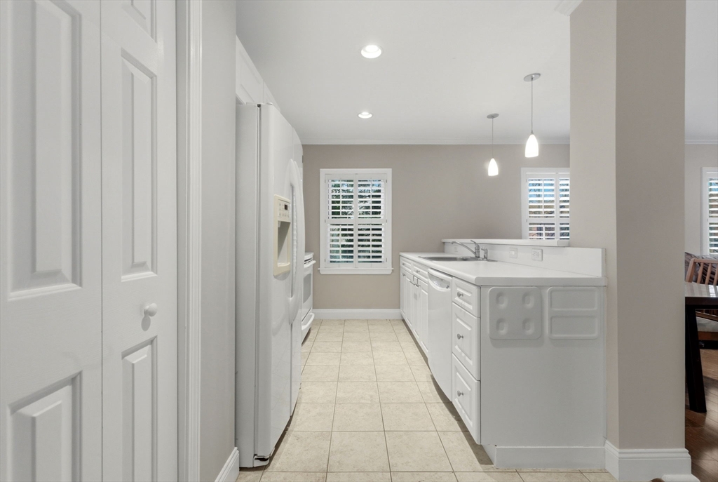 27 Commonwealth Avenue, Unit 1 Newton, MA 02467 - Photo 17 of 18 a bathroom with a sink a vanity and a mirror