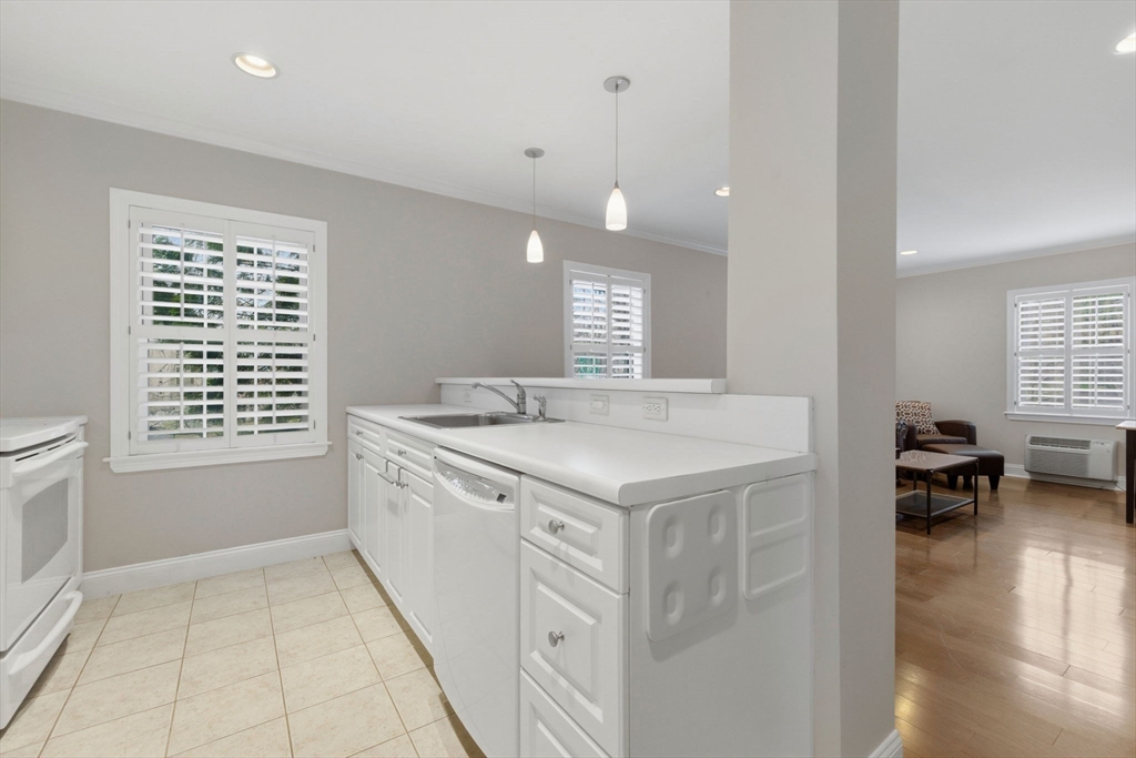 27 Commonwealth Avenue, Unit 1 Newton, MA 02467 - Photo 4 of 18 a kitchen with a stove and a sink