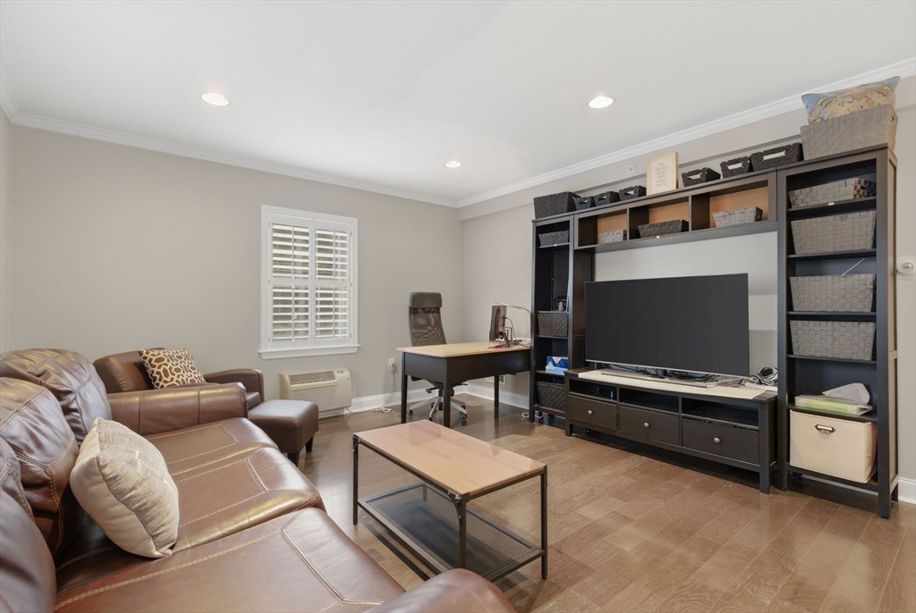 27 Commonwealth Avenue, Unit 1 Newton, MA 02467 - Photo 7 of 18 a living room with furniture and a flat screen tv