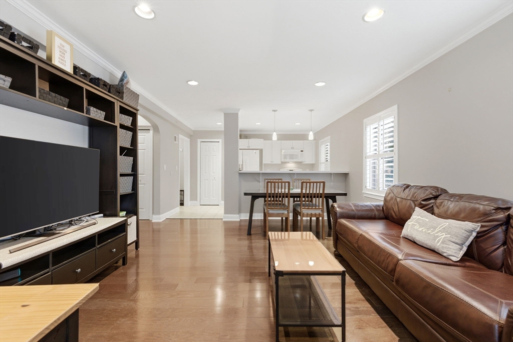 27 Commonwealth Avenue, Unit 1 Newton, MA 02467 - Photo 8 of 18 a living room with furniture and a flat screen tv
