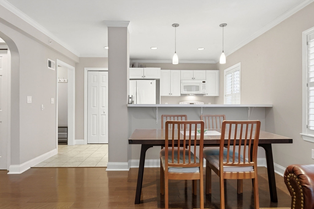 27 Commonwealth Avenue, Unit 1 Newton, MA 02467 - Photo 9 of 18 a view of kitchen with cabinets and wooden floor