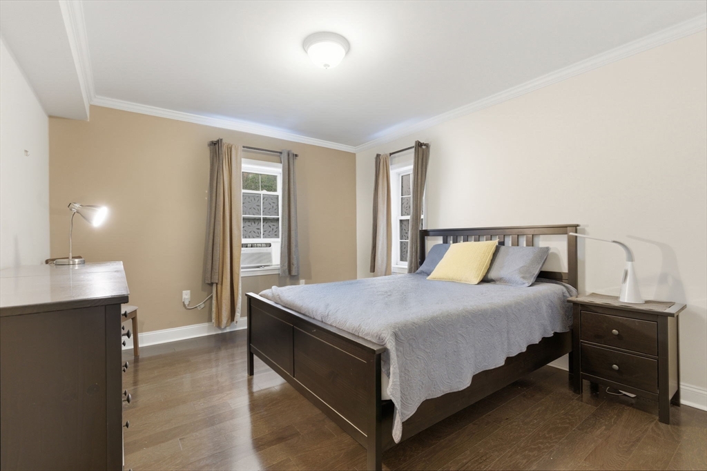 27 Commonwealth Avenue, Unit 1 Newton, MA 02467 - Photo 10 of 18 a bedroom with a bed and window