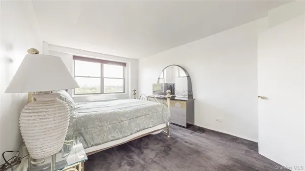 a bed room with a bed and a window