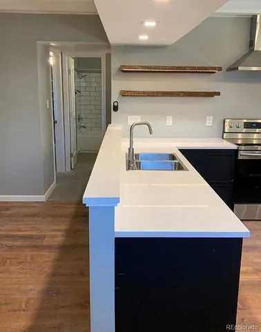 a kitchen with stainless steel appliances a refrigerator and a stove