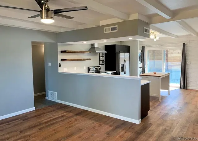 a kitchen with stainless steel appliances granite countertop a refrigerator and a sink