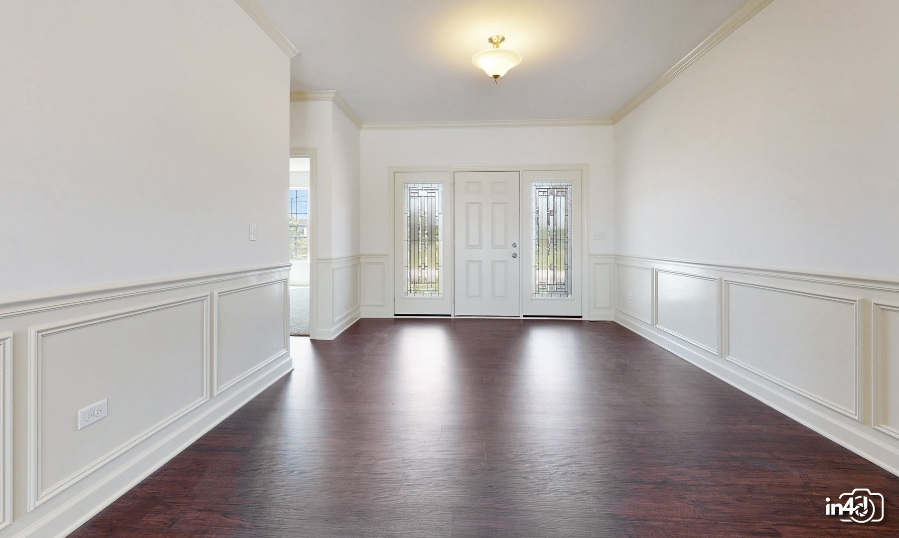 16436 Harmon Lane Plainfield, IL 60586 - Photo 3 of 30 a view of an empty room with wooden floor and a window
